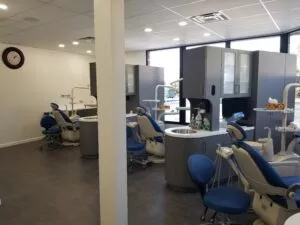 View of dental work chair at Crystal Bright Smile Dental Office in Tujunga, CA. The space is clean, and well-lit with a modern blue and white color motif.